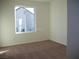 Comfortable bedroom with a large window and neutral carpeting at 3104 Naggio Shores Ave, Las Vegas, NV 89141