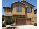Two-story home with tan stucco, brown trim, and a two-car garage at 3104 Naggio Shores Ave, Las Vegas, NV 89141