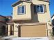 Tan two-story home with a two car garage and well kept front yard at 3104 Naggio Shores Ave, Las Vegas, NV 89141