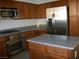 Modern kitchen featuring stainless steel appliances, granite countertops, and wooden cabinets at 3104 Naggio Shores Ave, Las Vegas, NV 89141