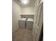 A laundry room with white appliances and tile flooring at 3104 Naggio Shores Ave, Las Vegas, NV 89141