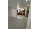 Open-concept living room and kitchen with tile and carpet flooring at 3104 Naggio Shores Ave, Las Vegas, NV 89141