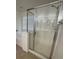 A new shower design with glass doors, new fixtures, and a bench at 3104 Naggio Shores Ave, Las Vegas, NV 89141