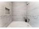 Close-up of the bathtub showcasing the tiled walls and decorative details at 3151 Soaring Gulls Dr # 1049, Las Vegas, NV 89128