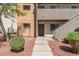 Well-maintained condo complex entrance with lush landscaping and inviting walkway at 3151 Soaring Gulls Dr # 1049, Las Vegas, NV 89128