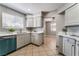 Bright kitchen featuring stainless steel appliances, tile flooring, neutral cabinetry and views into the dining area at 3151 Soaring Gulls Dr # 1049, Las Vegas, NV 89128