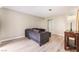 Well-lit living room showcasing a cozy gray sofa, wood-look flooring, and a console table with a lamp at 3151 Soaring Gulls Dr # 1049, Las Vegas, NV 89128