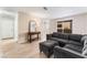 Comfortable living room featuring a gray sectional sofa, wood-look flooring, and a stylish console table at 3151 Soaring Gulls Dr # 1049, Las Vegas, NV 89128