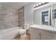 Bathroom featuring a tub with stylish tile surround, vanity, and modern lighting at 3151 Soaring Gulls Dr # 2113, Las Vegas, NV 89128