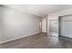 Bedroom showcasing a mirrored closet and access to the next room with new hard wood flooring at 3151 Soaring Gulls Dr # 2113, Las Vegas, NV 89128