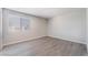 Bedroom with neutral walls, wood-look flooring, and natural light from a bright window at 3151 Soaring Gulls Dr # 2113, Las Vegas, NV 89128
