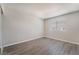 This bedroom features new gray hardwood floors and a large window, offering a simple, clean space at 3151 Soaring Gulls Dr # 2113, Las Vegas, NV 89128