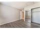 Bedroom showcasing a mirrored closet and access to the next room with new hard wood flooring at 3151 Soaring Gulls Dr # 2113, Las Vegas, NV 89128