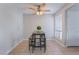 Bright dining area includes a gray table with seating under a ceiling fan and natural light from window at 3151 Soaring Gulls Dr # 2113, Las Vegas, NV 89128