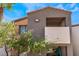 Exterior view of a condo featuring balconies and desert landscaping at 3151 Soaring Gulls Dr # 2113, Las Vegas, NV 89128