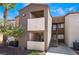 Exterior of condo building with balconies, stairs, and desert landscaping at 3151 Soaring Gulls Dr # 2113, Las Vegas, NV 89128