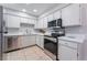 Bright kitchen featuring white cabinets, stainless steel appliances, and durable countertops at 3151 Soaring Gulls Dr # 2113, Las Vegas, NV 89128