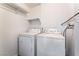 Laundry room with a standard washer and dryer unit and shelving above at 3151 Soaring Gulls Dr # 2113, Las Vegas, NV 89128