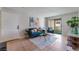 Inviting living room features a blue sofa, chair, decor, and sliding glass door to balcony at 3151 Soaring Gulls Dr # 2113, Las Vegas, NV 89128