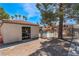 Exterior view of a community pool and changing room, surrounded by a fence and mature trees at 3151 Soaring Gulls Dr # 2113, Las Vegas, NV 89128