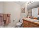 Cozy bathroom with warm tones featuring a single sink vanity, toilet, and towel racks at 405 Paradise Pkwy # 170, Mesquite, NV 89027