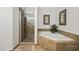 Bathroom featuring a glass shower and garden tub at 405 Paradise Pkwy # 170, Mesquite, NV 89027