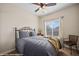 Comfortable bedroom with a large window, ceiling fan, and decorative metal bed frame at 405 Paradise Pkwy # 170, Mesquite, NV 89027