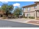 Exterior view of a condo building with balconies and well-maintained landscaping in a desert setting at 405 Paradise Pkwy # 170, Mesquite, NV 89027
