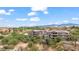 Modern condos are on a golf course with desert vegetation and mountain views under partly cloudy blue skies at 405 Paradise Pkwy # 170, Mesquite, NV 89027