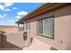 A view of the building's exterior, the balcony, and its neutral stucco finish and dark window trim at 405 Paradise Pkwy # 170, Mesquite, NV 89027
