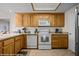 Traditional kitchen is equipped with stainless steel appliances, tile floor, and wood cabinets at 405 Paradise Pkwy # 170, Mesquite, NV 89027