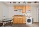 Kitchenette featuring wooden cabinets, a sink, and a washer/dryer combo at 405 Paradise Pkwy # 170, Mesquite, NV 89027