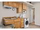 Kitchenette with wooden cabinets, a dining table, a sink, and a washer/dryer combo at 405 Paradise Pkwy # 170, Mesquite, NV 89027