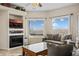 Bright living room featuring a fireplace, tv, and outdoor views at 405 Paradise Pkwy # 170, Mesquite, NV 89027