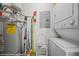 Utility room featuring a washing machine, dryer, water heater, and storage at 405 Paradise Pkwy # 170, Mesquite, NV 89027