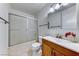 Bathroom featuring a sink, toilet, and a shower behind sliding frosted glass doors at 5199 Caliente St # 63, Las Vegas, NV 89119