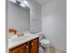 Powder room with a wooden vanity, white sink, and a tiled floor at 5199 Caliente St # 63, Las Vegas, NV 89119