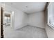 Bright bedroom with neutral carpet and walls, and a view to an adjacent room at 5199 Caliente St # 63, Las Vegas, NV 89119