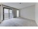 Bedroom features carpet, sliding glass doors to the balcony, and an ensuite bathroom at 5199 Caliente St # 63, Las Vegas, NV 89119