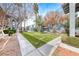 Exterior of apartment complex with green grass and manicured landscaping at 5199 Caliente St # 63, Las Vegas, NV 89119