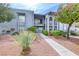 Charming condo with a well-maintained front yard, complemented by mature landscaping and a sidewalk leading to the entrance at 5199 Caliente St # 63, Las Vegas, NV 89119