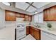 Well-equipped kitchen featuring oak cabinets, a double sink, and ample counter space at 5199 Caliente St # 63, Las Vegas, NV 89119