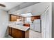 Well-lit kitchen featuring oak cabinets, tile floors, and modern appliances including a gas range and refrigerator at 5199 Caliente St # 63, Las Vegas, NV 89119
