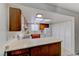 Eat-in kitchen features wood cabinets, white appliances, and neutral countertops at 5199 Caliente St # 63, Las Vegas, NV 89119