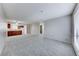 Bright living room area adjacent to kitchen, featuring neutral walls and plush carpet flooring at 5199 Caliente St # 63, Las Vegas, NV 89119