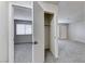 Spacious living room with neutral carpet and walls, with views into the bedroom and closet at 5199 Caliente St # 63, Las Vegas, NV 89119