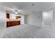 Cozy living space open to the kitchen, complemented by plush carpet flooring and neutral walls at 5199 Caliente St # 63, Las Vegas, NV 89119