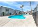 Community pool surrounded by apartment buildings and palm trees at 5199 Caliente St # 63, Las Vegas, NV 89119