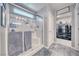 Bright bathroom featuring a glass shower, wood-look floors, and access to a walk-in closet at 5360 S Chippewa St, Pahrump, NV 89061