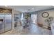 Bright dining area featuring a glass table, wicker chairs, natural light, and access to an outdoor patio at 5360 S Chippewa St, Pahrump, NV 89061